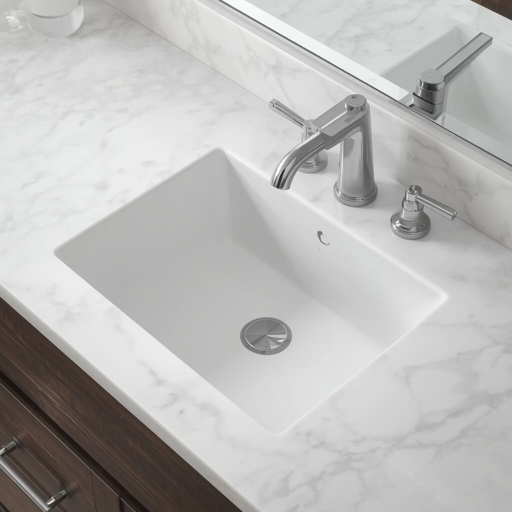 White quartz countertop with an undermount bathroom sink.